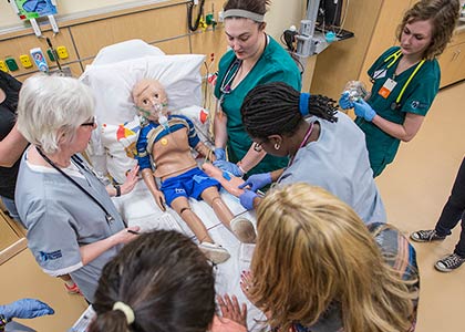 nurses gather around simulation model