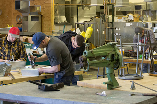 students working with sheet metal