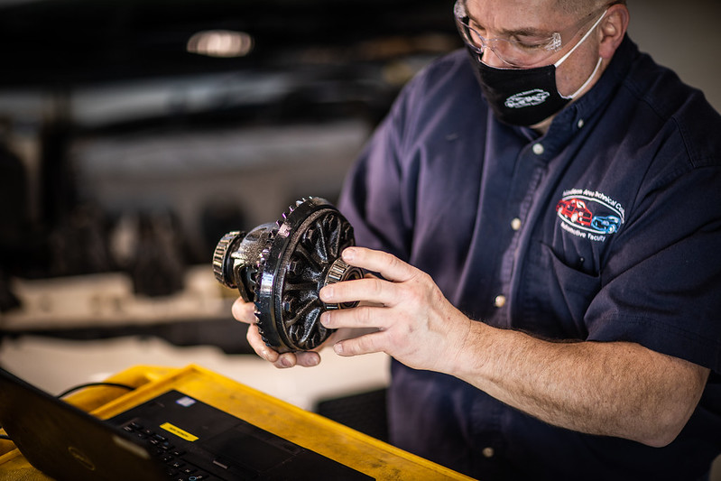 man works with mechanic tool while learning