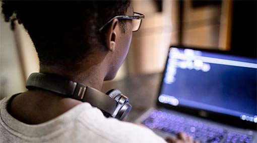 student looking at a laptop screen